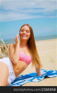 Technology and communication. Happy smiling woman with mobile phone calling to people friends. Young attractive girl talking by smartphone on beach.. Woman on beach talking by mobile phone.