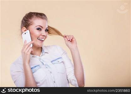 Technology and communication. Lovely fashionable teen girl using mobile phone talking, positive smiling face expression. Girl using mobile phone talking