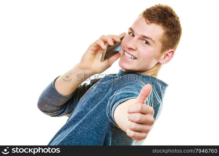 Technology and communication. Young man casual style talking on mobile cell phone using smartphone making thumb up hand sign gesture isolated on white