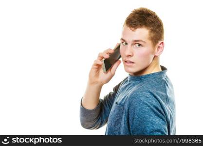 Technology and communication. Young man casual style talking on mobile cell phone using smartphone isolated on white
