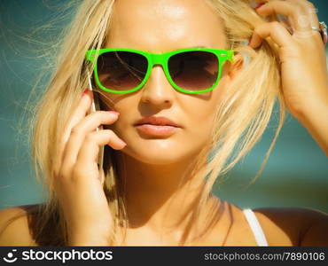 Technology and communication. Young woman pretty girl talking on mobile cell phone using smartphone on beach