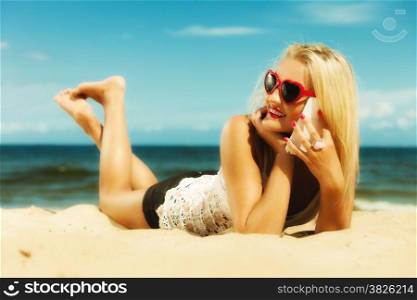 Technology and communication. Young woman teen girl talking on mobile cell phone using smartphone on beach