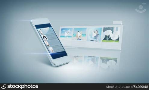 technology and entertainment concept - white smarthphone with videon on screen