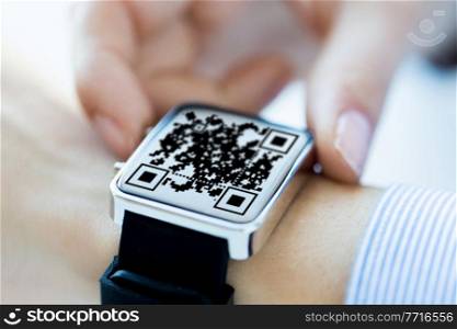 technology and health care concept - close up of woman&rsquo;s hands with qr code on smart watch at office. woman&rsquo;s hands with qr code on smart watch