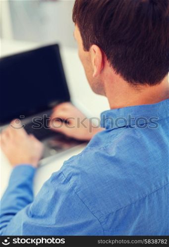 technology and internet concept - close up of man with laptop computer