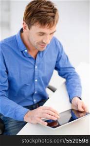 technology and lifestyle, distance learning concept - handsome man working with tablet pc at home