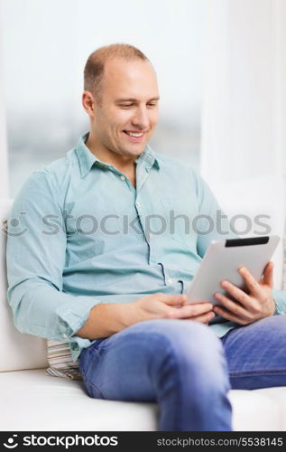 technology and lifestyle, distance learning concept - handsome man working with tablet pc at home