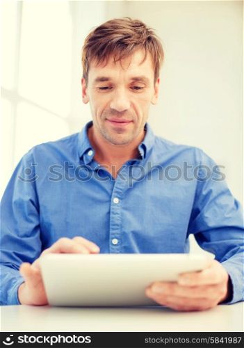 technology and lifestyle, distance learning concept - handsome man working with tablet pc at home
