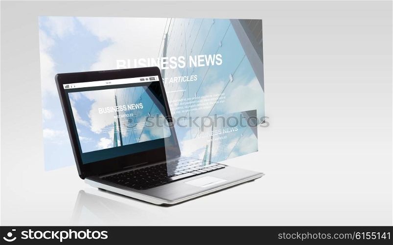 technology and mass media concept - laptop computer with business news on screen. laptop computer with business news on screen