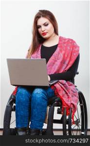 Technology and mobile equipment. Disabled handicapped girl with laptop computer. Young woman business worker on wheelchair.. Disabled woman with laptop on wheelchair.