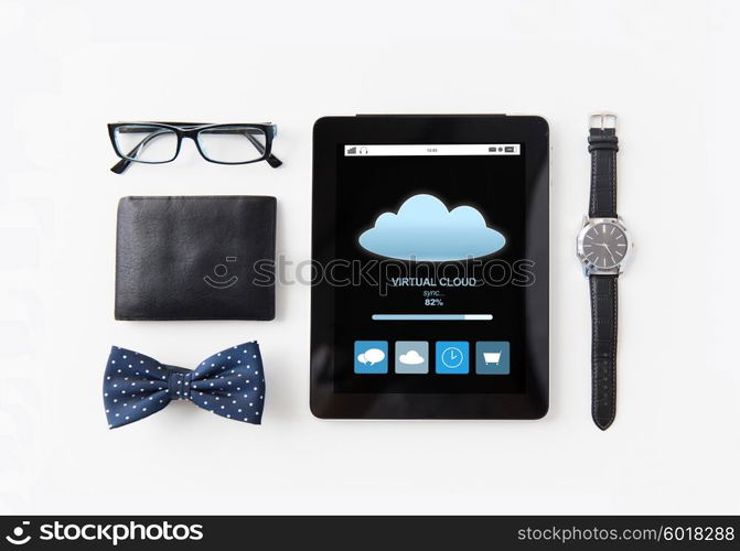 technology and objects concept - tablet pc computer with cloud computing process, wallet, eyeglasses, bowtie and wristwatch on table