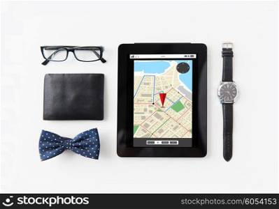 technology and objects concept - tablet pc computer with gps navigator map, wallet, eyeglasses, bowtie and wristwatch on table
