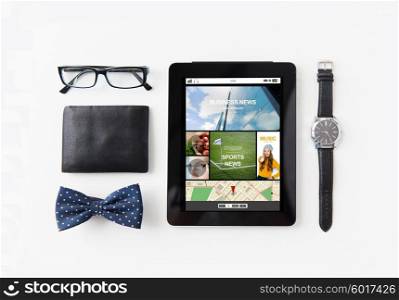 technology and objects concept - tablet pc computer with internet applications , wallet, eyeglasses, bowtie and wristwatch on table