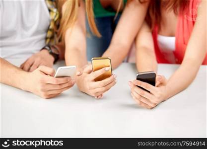 technology and people concept - close up of hands with smartphones. close up of hands with smartphones