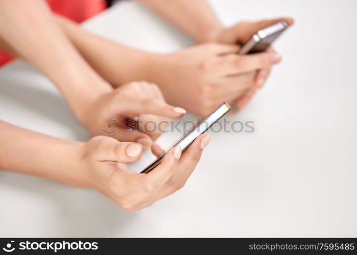 technology and people concept - close up of hands with smartphones. close up of hands with smartphones