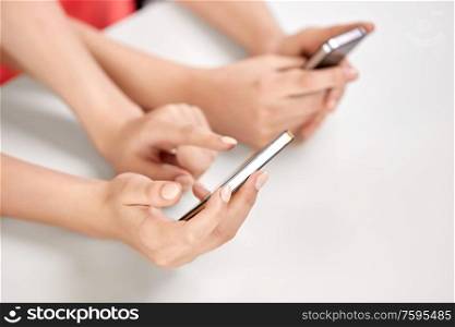 technology and people concept - close up of hands with smartphones. close up of hands with smartphones