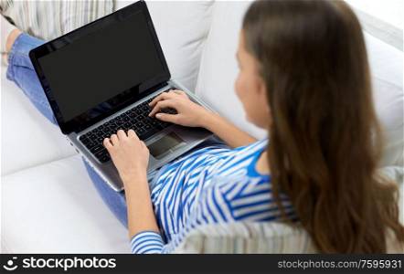 technology and people concept - close up of teenage girl typing on laptop at home. close up of teenage girl typing on laptop at home