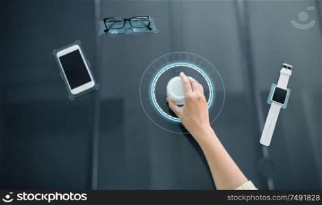 technology and people concept - close up of woman&rsquo;s hand using rotary control knob on interactive panel with virtual hologram. hand with control knob on interactive panel
