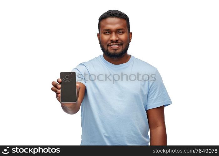 technology and people concept - happy young african american man showing smartphone over white background. happy african american man with smartphone