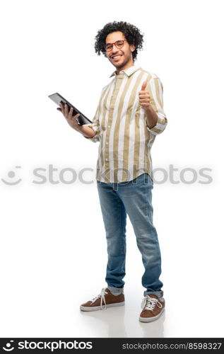 technology and people concept - happy young man in glasses with tablet pc computer showing thumbs up gesture over white background. happy young man with tablet pc showing thumbs up