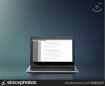 technology and programming concept - laptop computer with coding on screen over gray background. laptop computer with coding on screen