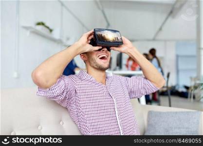 technology, augmented reality and people concept - happy man with singapore city on virtual headset screen laughing at office. happy man with virtual reality headset at office