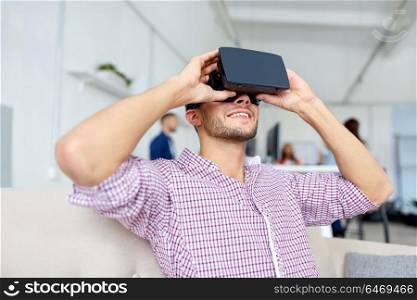 technology, augmented reality and people concept - happy man with virtual headset at office. happy man with virtual reality headset at office