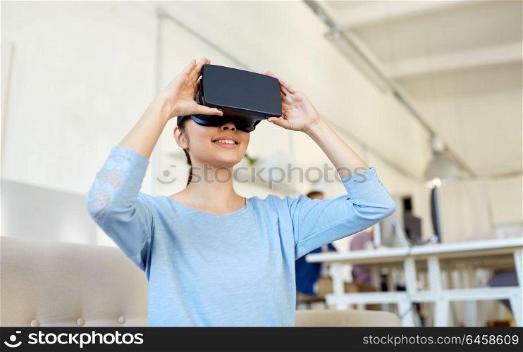 technology, augmented reality and people concept - happy woman with virtual headset at office. happy woman with virtual reality headset at office