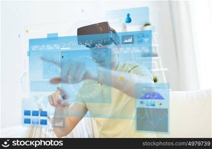 technology, augmented reality, big data and people concept - happy young man with virtual headset or 3d glasses pointing finger to screens projection. young man in virtual reality headset or 3d glasses