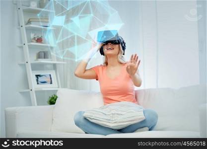technology, augmented reality, cyberspace and people concept - happy young woman in headset or 3d glasses and headphones playing game at home looking at virtual projection of low poly shape