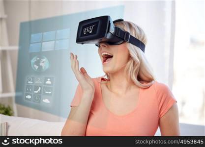 technology, augmented reality, cyberspace, e-commerce and people concept - happy amazed young woman in virtual headset or 3d glasses at home with shopping cart and menu icons on screen projection. woman in virtual reality headset or 3d glasses
