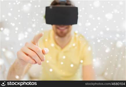 technology, augmented reality, entertainment and people concept - close up of happy young man with virtual headset or 3d glasses playing game at home over snow