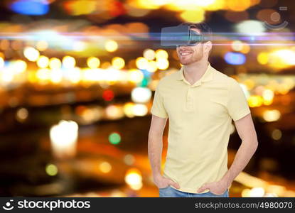 technology, augmented reality, entertainment and people concept - happy young man with virtual headset or 3d glasses over night lights background. happy man in virtual reality headset or 3d glasses