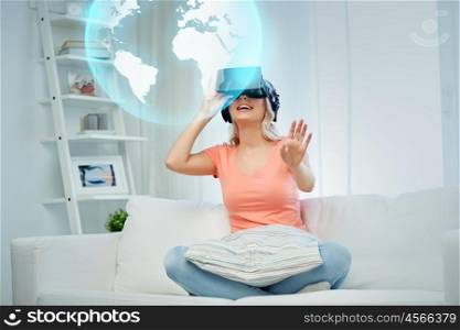 technology, augmented reality, entertainment and people concept - happy young woman in virtual headset or 3d glasses and headphones playing game at home looking at projection of earth globe