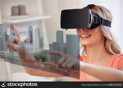 technology, augmented reality, entertainment and people concept - happy young woman in virtual headset or 3d glasses and headphones playing game at home with city skyscrapers on screen projection. woman in virtual reality headset with city