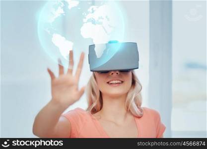 technology, augmented reality, entertainment and people concept - happy young woman with virtual headset or 3d glasses playing game at home looking at projection of earth globe