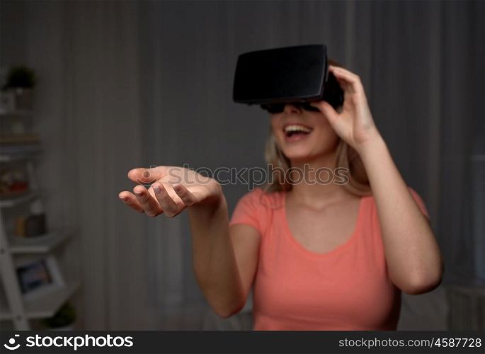 technology, augmented reality, entertainment and people concept - happy young woman with virtual reality headset or 3d glasses holding or catching something invisible