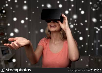 technology, augmented reality, entertainment and people concept - happy young woman with virtual headset or 3d glasses playing game at home and holding something invisible. woman in virtual reality headset or 3d glasses