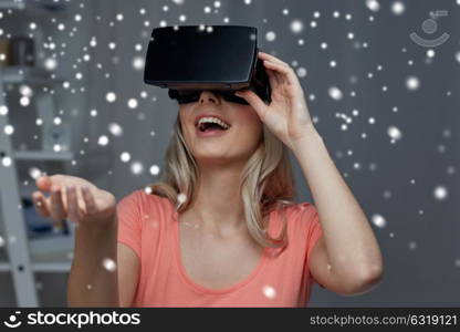 technology, augmented reality, entertainment and people concept - happy young woman with virtual headset or 3d glasses playing game at home and holding something invisible. woman in virtual reality headset or 3d glasses