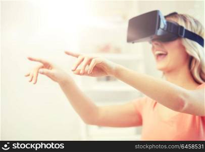 technology, augmented reality, entertainment and people concept - happy young woman with virtual reality headset or 3d glasses touching something invisible. woman in virtual reality headset or 3d glasses