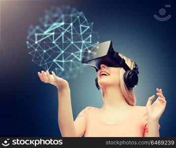 technology, augmented reality, entertainment and people concept - happy young woman with virtual headset or 3d glasses over dark blue background and low poly projection. woman in virtual reality headset or 3d glasses
