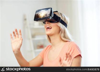 technology, augmented reality, entertainment and people concept - happy young woman with virtual headset or 3d glasses playing video game with singapore city on screen at home. woman in virtual reality headset or 3d glasses. woman in virtual reality headset or 3d glasses