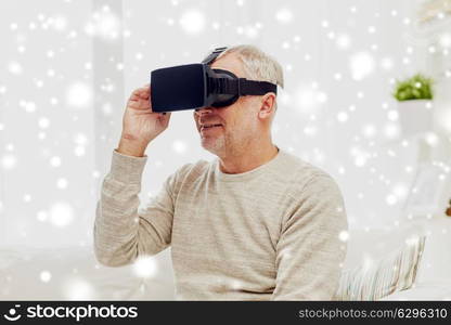 technology, augmented reality, entertainment and people concept - senior man with virtual headset or 3d glasses playing videogame at home over snow. old man in virtual reality headset or 3d glasses