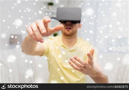 technology, augmented reality, gaming, entertainment and people concept - close up of young man with virtual headset or 3d glasses playing videogame at home over snow
