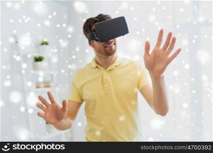 technology, augmented reality, gaming, entertainment and people concept - close up of happy young man with virtual headset or 3d glasses playing videogame at home over snow