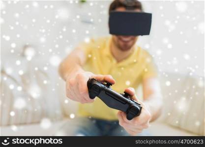 technology, augmented reality, gaming, entertainment and people concept - close up of happy young man with virtual headset or 3d glasses playing video game with controller gamepad at home over snow