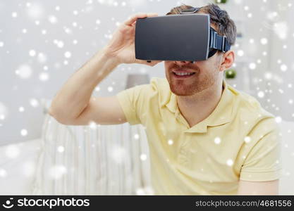 technology, augmented reality, gaming, entertainment and people concept - happy young man with virtual headset or 3d glasses playing video game over snow