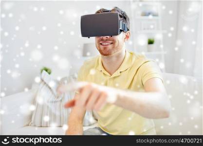 technology, augmented reality, gaming, entertainment and people concept - happy young man with virtual headset or 3d glasses playing video game over snow