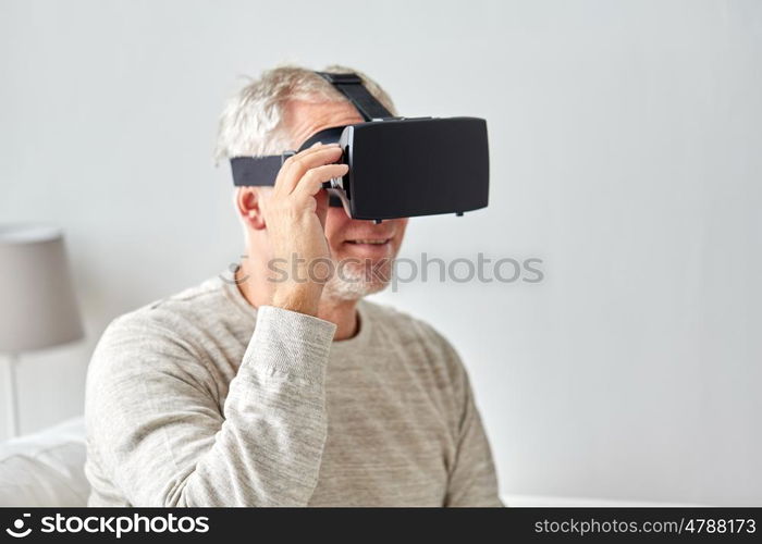 technology, augmented reality, gaming, entertainment and people concept - senior man with virtual headset or 3d glasses playing videogame at home