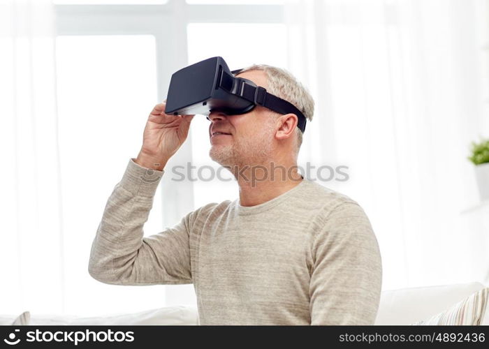 technology, augmented reality, gaming, entertainment and people concept - senior man with virtual headset or 3d glasses playing videogame at home